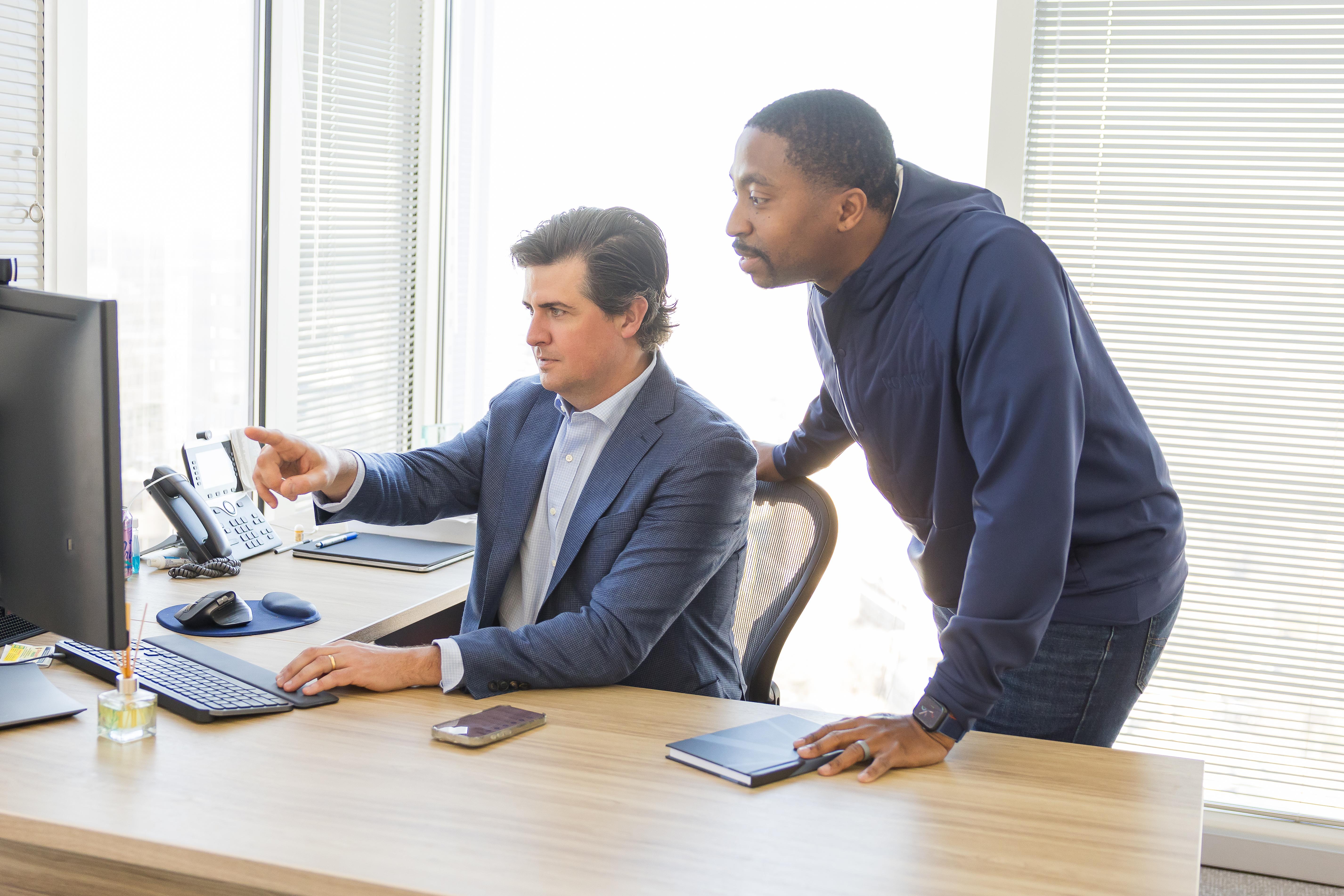 Two men looking at computer