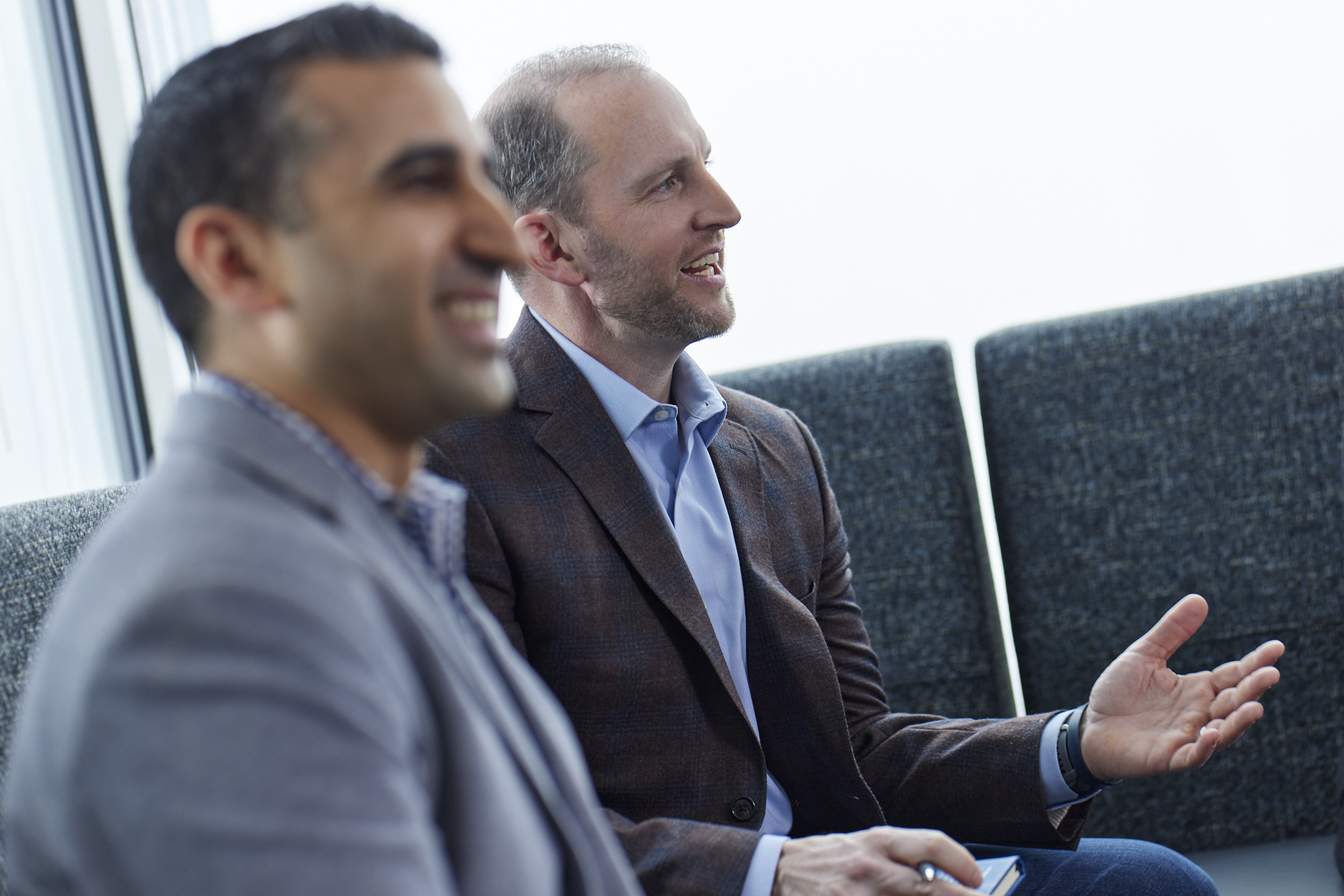 2 men listening to someone speak